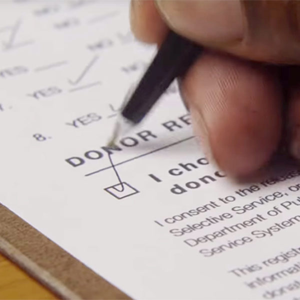 An individual checking the donor box on a form
