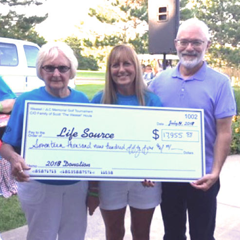 Contribution check for over $17,000 being given to LifeSource at the Weasel golf tournament